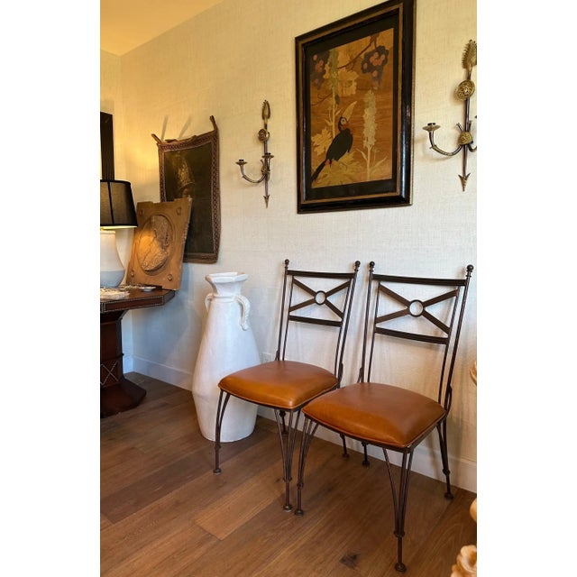 Fabulous pair of Mid-Century iron and leather dining or accent chairs. Hand-forged iron with Art-Deco and Spanish-Regency...