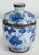 Vintage porcelain vibrant blue and white floral motif lidded jar. Brass strip at frame and handle. Patina to brass. No...