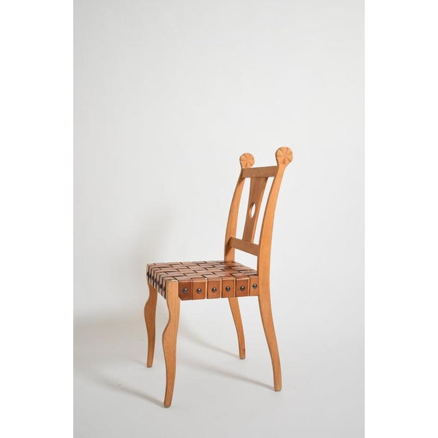Pair of etruscan oak and leather chairs, 1970s. Height: 95 cm - 37.4 in Length: 48 cm - 18.9 in Width: 47 cm - 18.5 in...