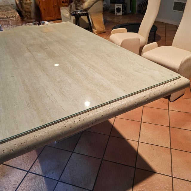 6ft vintage Italian travertine dining table on matching travertine pedestal. It has a protective glass cover, which can be...