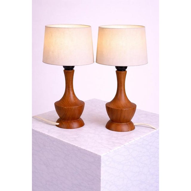 A charming pair of scandinavian modern table lamps by markslöjd, sweden, dating to the 1950s. Crafted in solid teak, the...