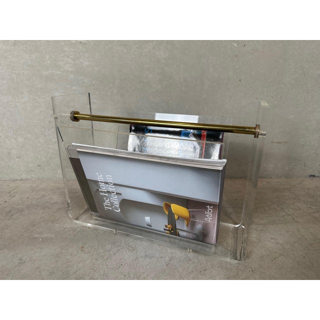 Vintage acrylic glass newspaper or magazine holder. Presumably designed by David Lange for Roche Bobois, in 1970. Brass...