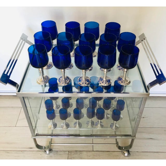 Rare chrome bar cart with enclosed glass cabinet. With sliding glass panels doors on front. Designed by Treitel Gratz a...