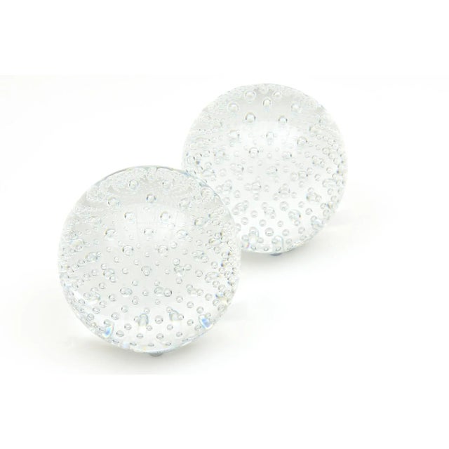 This pair of heavy clear glass large balls of abundant internal bubbles or bullecante look like infinity. They make a...