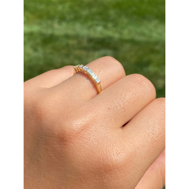 The Kerwin Road: Bar Set Princess Cut Natural Diamond Ring in Yellow Gold. The ring features a larger princess-cut natural...