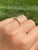The Kerwin Road: Bar Set Princess Cut Natural Diamond Ring in Yellow Gold. The ring features a larger princess-cut natural...