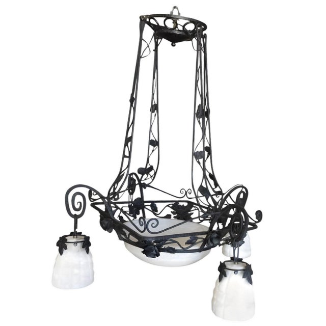 Exceptional Bespoke custom made French Country style 4-light chandelier showcases the exquisite artistry of black iron...