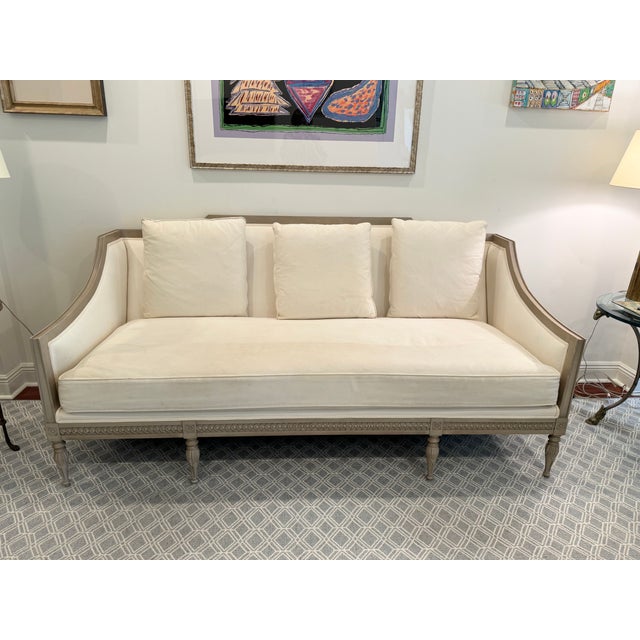 This wood framed sofa in white linen upholstery features a clean natural silhouette and can be dressed up with added...