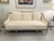 This wood framed sofa in white linen upholstery features a clean natural silhouette and can be dressed up with added...