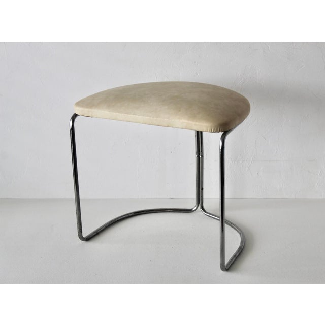 Vintage Bauhaus-style tan seat chrome tubular cantilevered stool. Tubular chrome and off-white upholstered, lightly padded...
