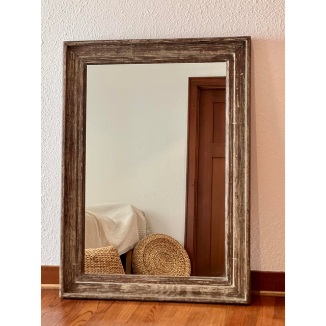 Add timeless charm and character to your space with this rustic wood-framed wall mirror. Measuring 46 inches tall by 33.5...