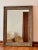 Add timeless charm and character to your space with this rustic wood-framed wall mirror. Measuring 46 inches tall by 33.5...