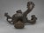 Pair of Grand Tour Bronze Two-Light Candlesticks in Roman Oil-Lamp Form A pair of patinated bronze candlesticks, probably...