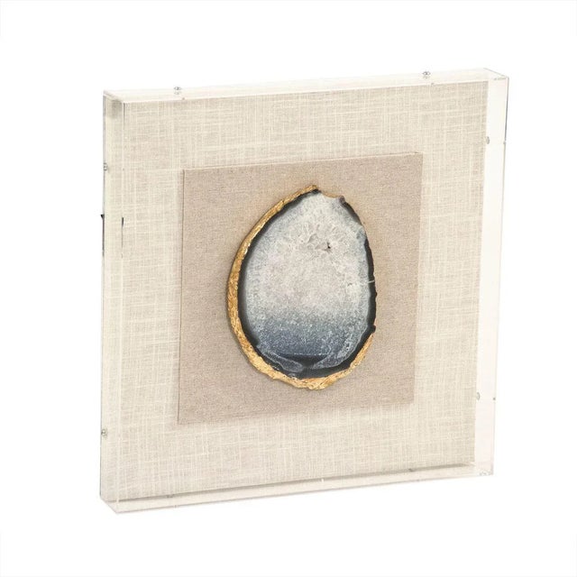 Blue geode cross section affixed against beige background. Cased in Acrylic.