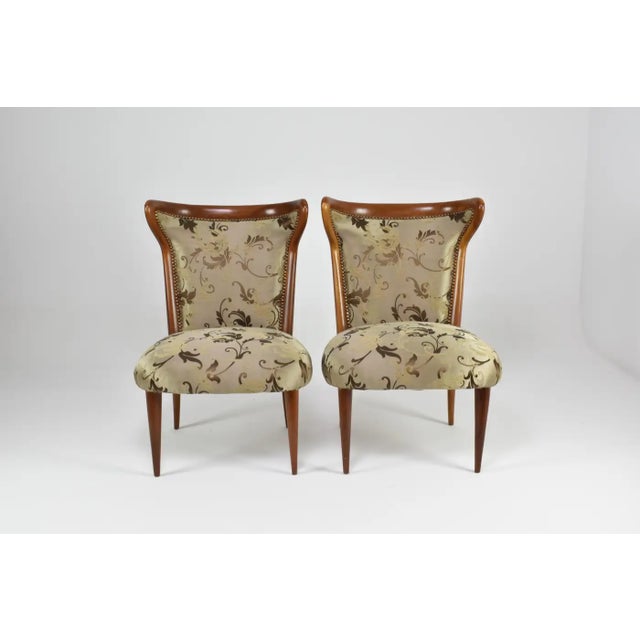 A pair of mid-century Italian chairs distinguished by their sculptural silhouette and exquisite restoration. The exposed...