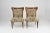 A pair of mid-century Italian chairs distinguished by their sculptural silhouette and exquisite restoration. The exposed...