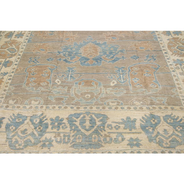 Beautiful modern Sultanabad hand-knotted wool rug with a light brown color field. This rug has blue accents in a gorgeous...