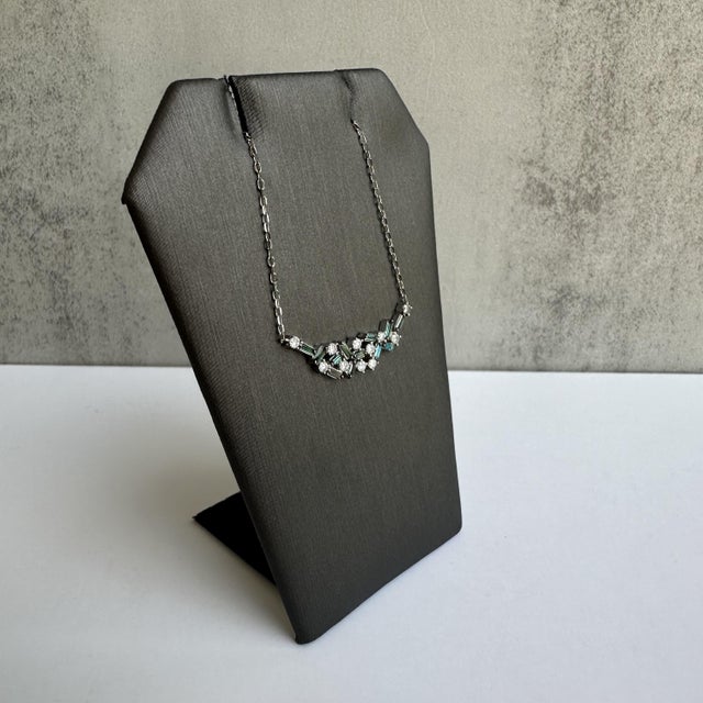 Introducing a chic and contemporary 10kt White Gold Blue and White Diamond Bar Necklace, featuring a total of 0.50ctw of...