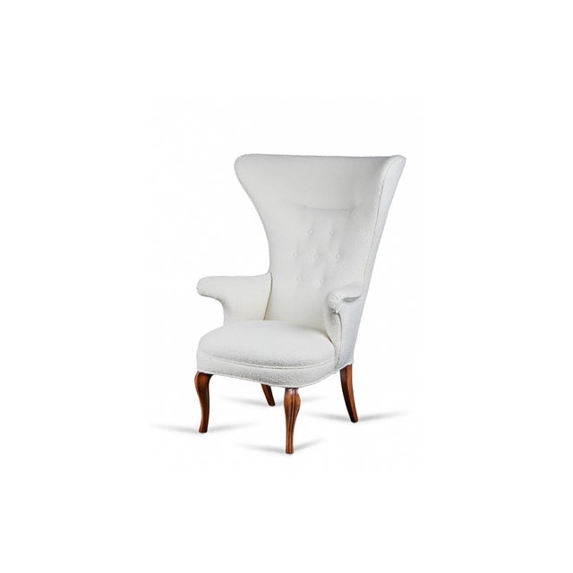 Dramatic and sculptural wing chair in the style of Fritz Henningsen, from the estate of French fashion designer Christian...