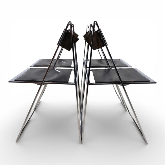 This delicate and elegant set of four folding chairs in chrome and leather is in excellent condition. Designed in 1969 by...