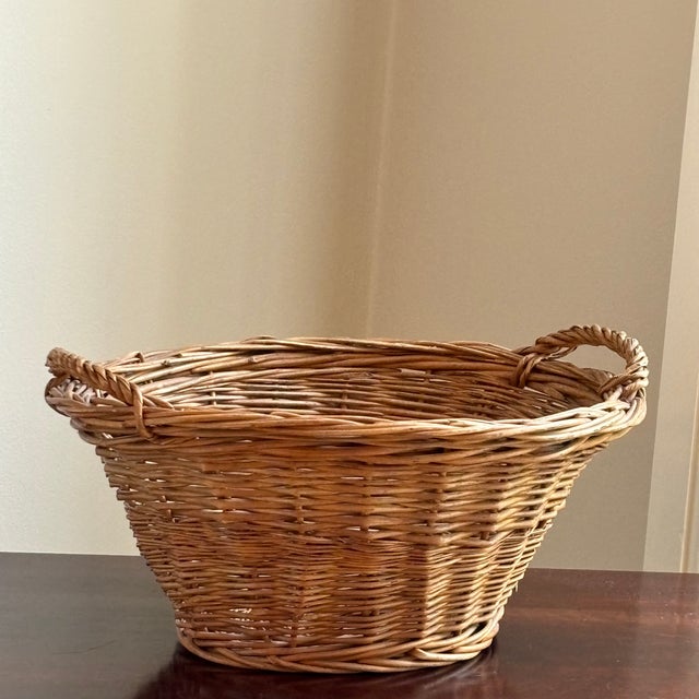 Offering a small mid-20th century rustic farmhouse basket. Perfect for use as a gathering basket in the garden, as a handy...