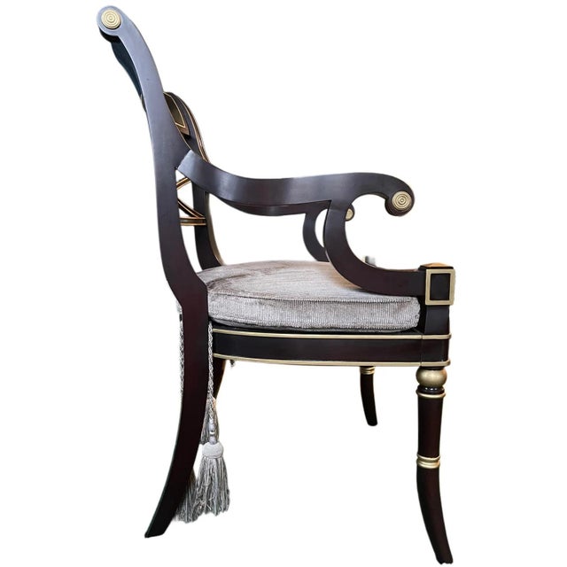 A refined custom-made neoclassical armchair produced in 2017 by Kindel Furniture, executed in a deep ebony finish with...