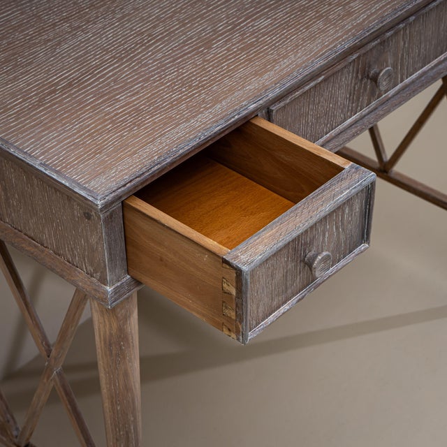 Pair of desks in limed oak featuring a lattice structure between the side legs and three drawers each. Charming gray and...