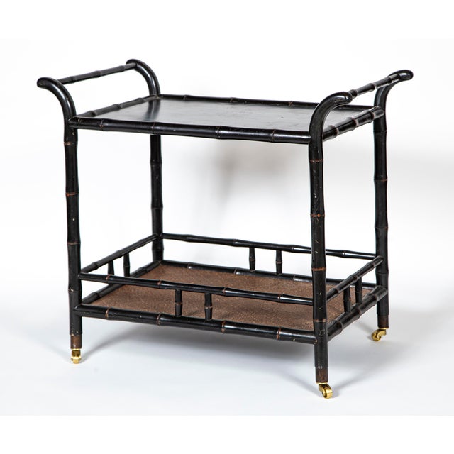 Vintage Ebonized Faux Bamboo Bar Cart, 20th Century. Two tier trolley with the bottom surface in woven rattan. Polished...