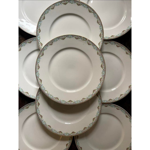 The loveliest fine china plates from Limoges, presented in a crisp white. Around the rim, a garland drapes in green...