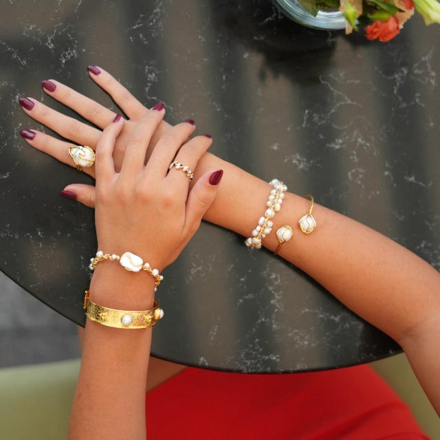 Add a touch of mysticism to your style with the Baroque Pearl Gold Design Isis Chunky Ring. This captivating ring features...