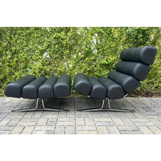 Chrome and vegan leather lounge chair + ottoman set in the style of British designer William Plunkett. The “Kingston”...