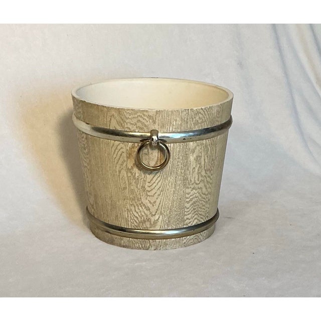 Mid-Century faux wood grain planter or bucket featuring gold-colored metal bands and attached ring handles. 13 inches wide...