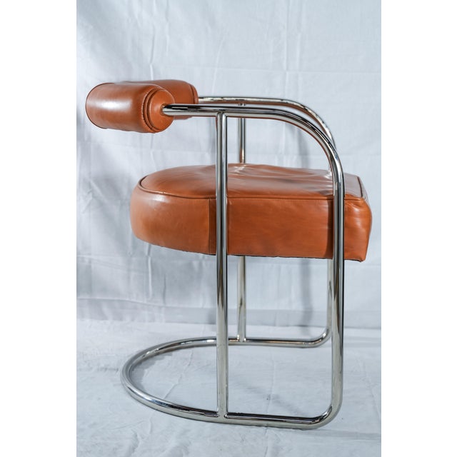 Bauhaus-esque dining chair (or low stool) with tubular, stainless steel architecture.