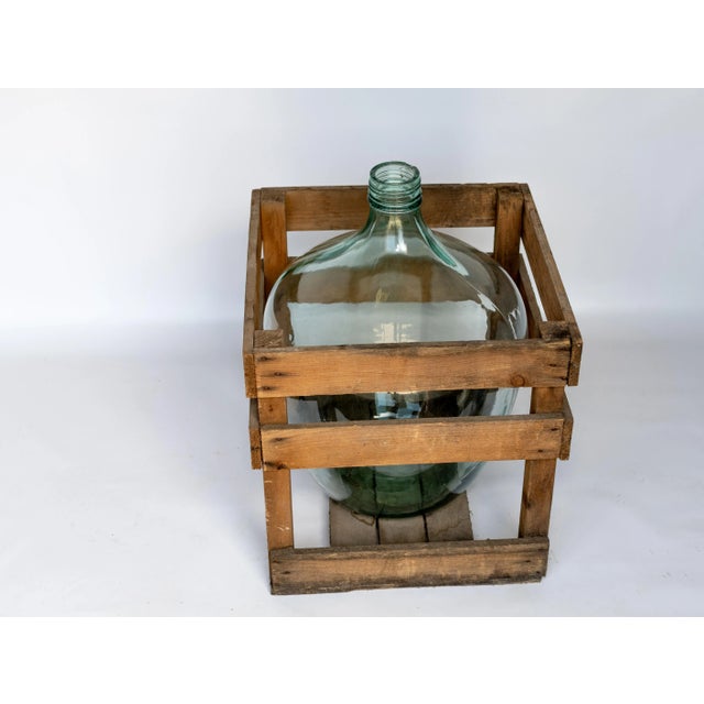 Demijohn glass bottle with wood crate. Originally used through out Europe both for fermenting and transporting of...