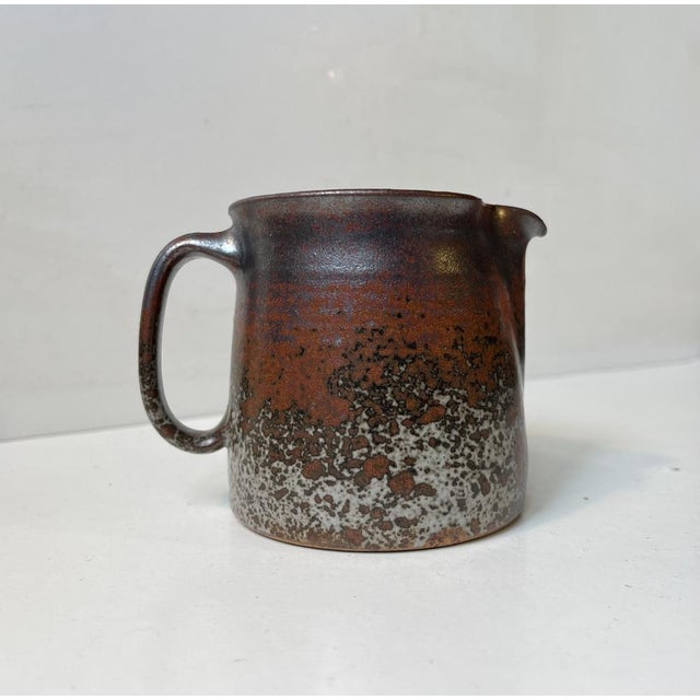 Small exceptional stoneware jug heavily decorated with earthy crystalline glazes by jacob bang. The kid brother of arne...