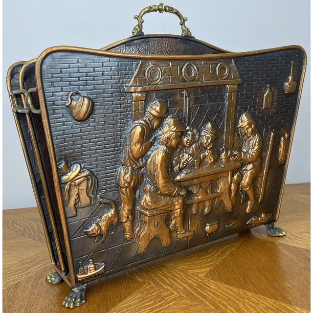 An elegant Vintage newspapper rack featuring richly embossed figural tavern scenes to both sides, creating a wonderfully...