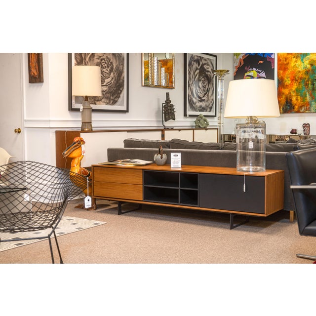 A Treku media console cabinet. This is a lovely contemporary made cabinet in the styling of a classic mid century modern...