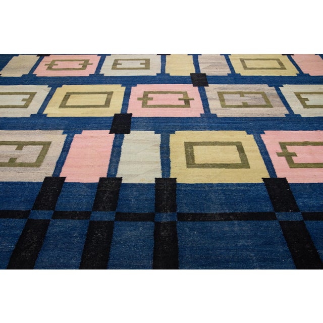 Beautiful Contemporary Kilim flatweave wool rug with a navy blue color field. This Oversize rug features a gorgeous...