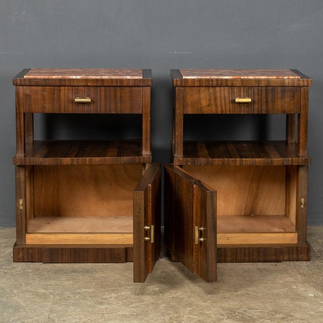 Mid 20th Century pair of Italian bedside cabinets, made out of kingwood with a rose marble top. They each with a single...