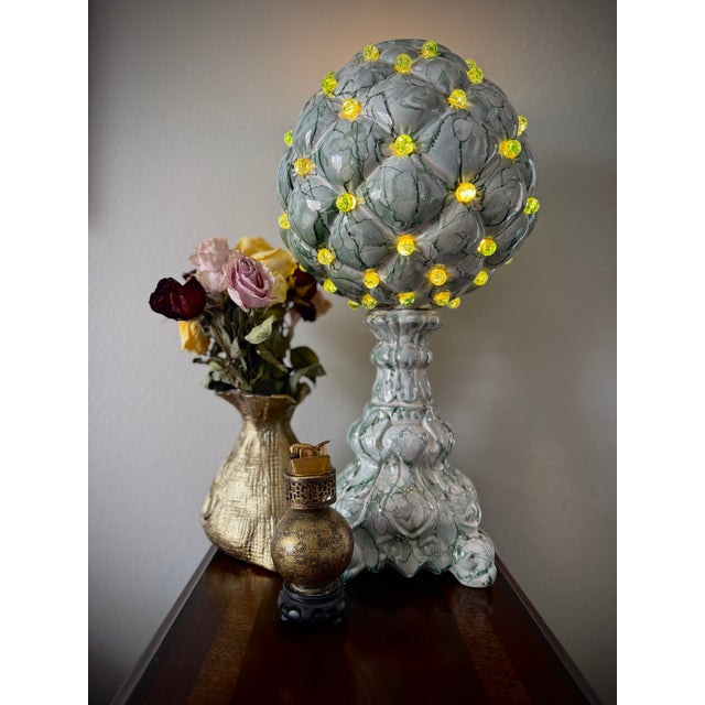 Striking vintage table lamp featuring a sculptural ceramic form with a marbleized green drip glaze and dimensional...