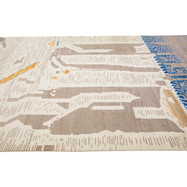 Beautiful moroccan berber style hand-knotted wool rug with a beige field. This piece has multicolor accents in an all-over...