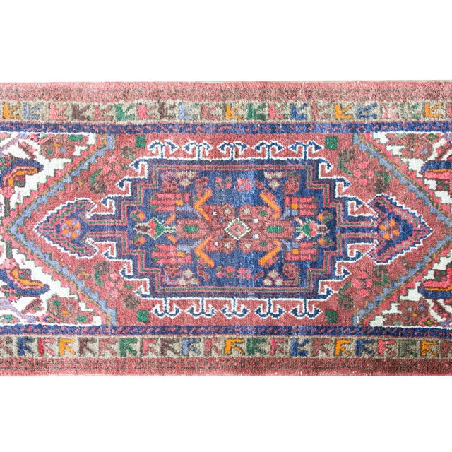 A beautify early 20th century Persian Mazlaghan rug with a tribal pattern containing stylized flowers and scrolling vines,...