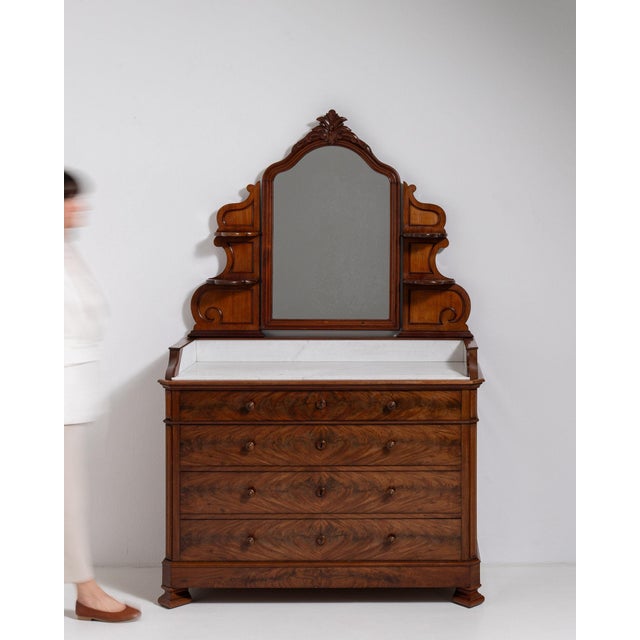This piece presents as a chest of drawers, distinguished by dark mahogany, turned wood knob. The piece dates to 19th...