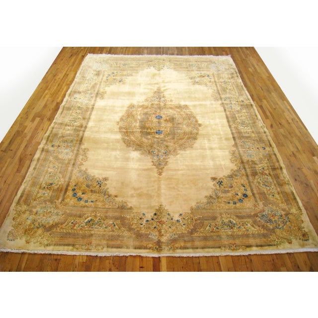 Vintage Persian Kerman oriental carpet, size 15'0" H x 10'0" W, circa 1940. This vintage hand-knotted Persian rug features...