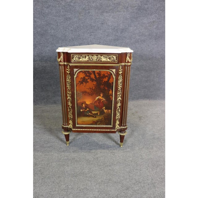 Presenting a superb French Louis XVI–style paint-decorated corner cabinet signed Millet, a refined and beautifully crafted...