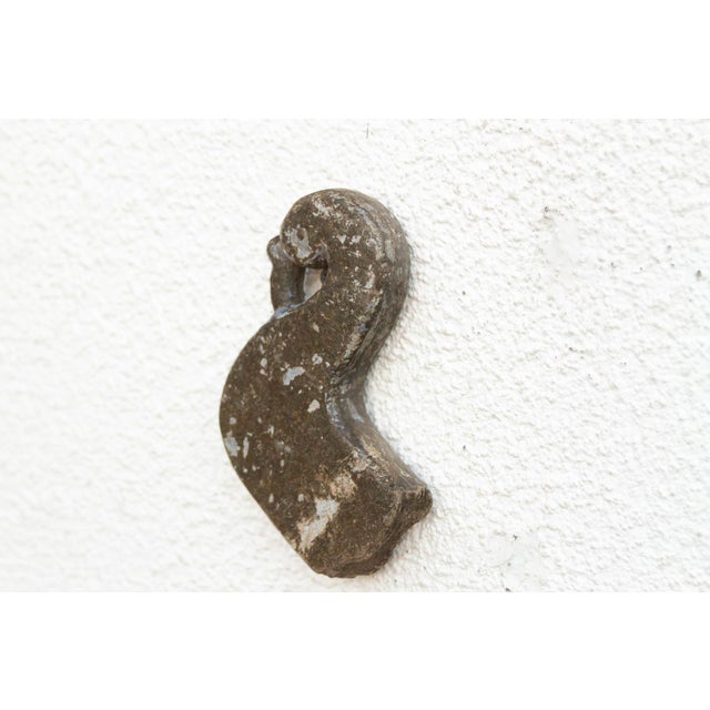 A pocket-sized piece of history, this small stone fragment was once part of the architectural fabric of a traditional...