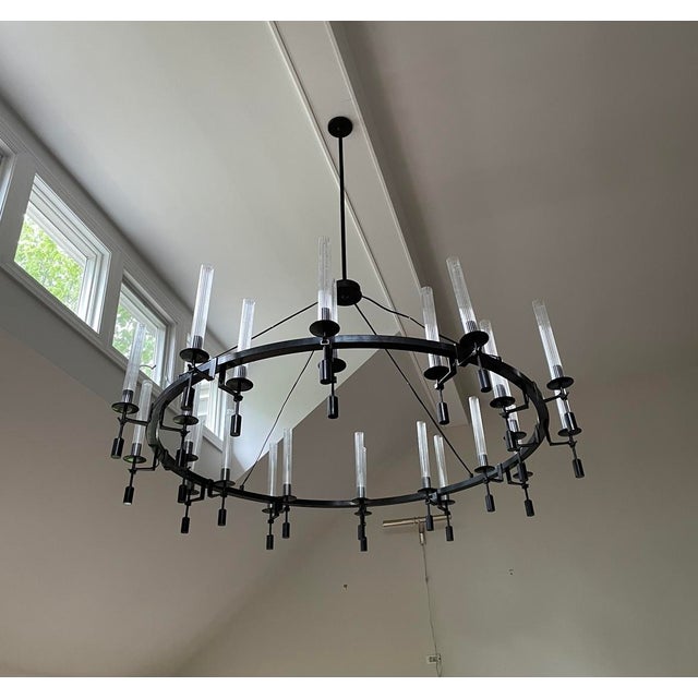 70" diameter, this is a statement-making black iron chandelier with bulbs and glass shades that glow in the evening and...