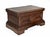 A robust and characterful wooden coffer of rectangular form, raised on a molded plinth base with shaped apron. The façade...