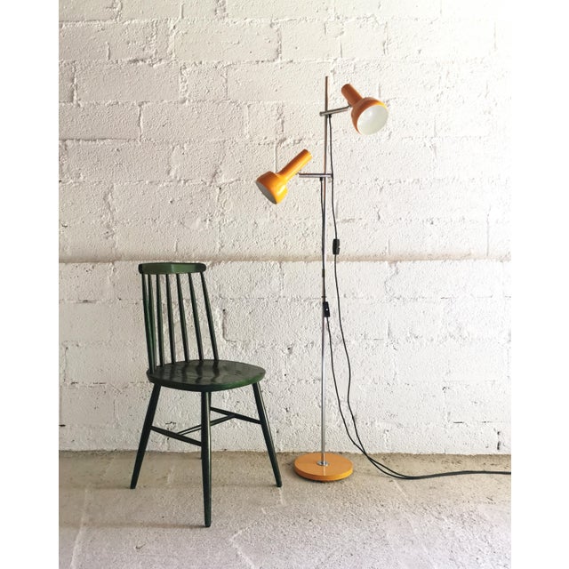This two-light floor lamp is from Germany and was designed in the 1970s in typical space age style. It is made of chrome-...