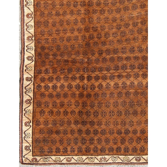 Set on a brown field with an all-over modern/Mid-Century Modern pattern, this beautiful vintage Kars rug (circa mid-20th...